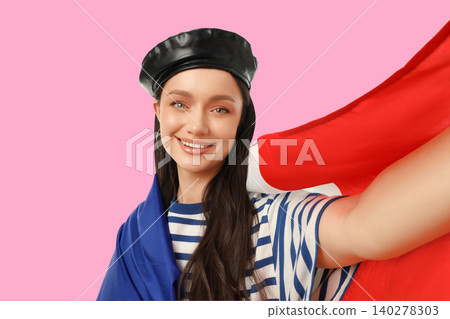 Woman smiles while draping flag over herself. Travel and cultural identity concept Woman smiles while draping flag over herself. Travel and cultural identity concept 140278303
