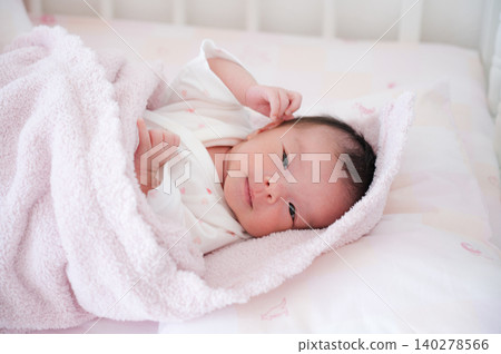 Baby wrapped in a pink towel Baby wrapped in a pink towel 140278566
