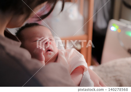 Baby sleeping in a mother's embrace Baby sleeping in a mother's embrace 140278568