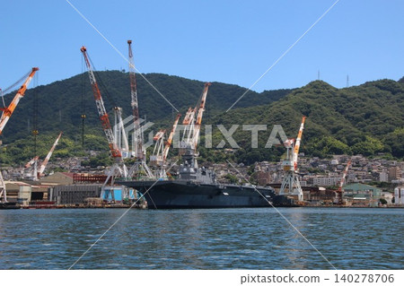 The destroyer "Kaga" is undergoing modifications while docked in Kure Port. 140278706