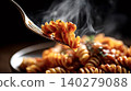 Fork lifting steaming fusilli pasta with tomato sauce 140279088