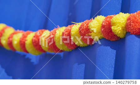 India day moscow celebrating with marigold garland decoration on blue background India day moscow celebrating with marigold garland decoration on blue background 140279758