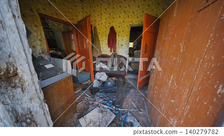 Decaying interior of an abandoned house displaying neglect and forgotten memories 140279782