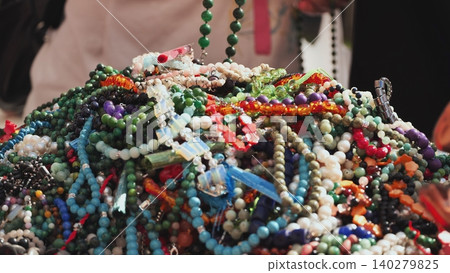 Colorful necklaces and bracelets creating a vibrant indian market stall display Colorful necklaces and bracelets creating a vibrant indian market stall display 140279825