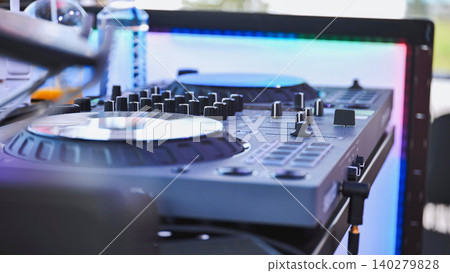 Dj set with mixer and colorful led panel lighting up the background Dj set with mixer and colorful led panel lighting up the background 140279828