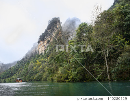 View of the peaks of the mountains in the fog on Lake Baofeng in the vicinity of Zhangjiajie, China View of the peaks of the mountains in the fog on Lake Baofeng in the vicinity of Zhangjiajie, China 140280529