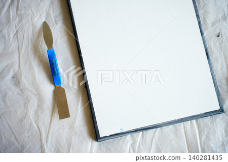 Blank canvas prepared with palette knife on protective sheet Blank canvas prepared with palette knife on protective sheet 140281435