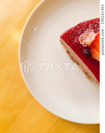 A delectable slice of cake with rich layers of cream and frosting, topped with fresh fruit or sprinkles. Perfect for dessert photography, showcasing indulgence and sweetness in food-related projects. 140281465