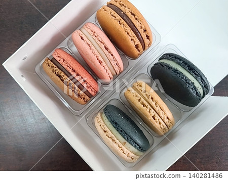Colorful macarons with a delicate, crispy shell and soft, flavorful filling. Perfect for dessert photography, showcasing these elegant French treats in a variety of flavors and vibrant pastel colors. Colorful macarons with a delicate, crispy shell and soft, flavorful filling. Perfect for dessert photography, showcasing these elegant French treats in a variety of flavors and vibrant pastel colors. 140281486