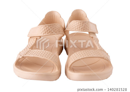 Beige Rubber Summer Sandals isolated on white background. Women Waterproof Lightweight Beach pair Shoes Beige Rubber Summer Sandals isolated on white background. Women Waterproof Lightweight Beach pair Shoes 140281528