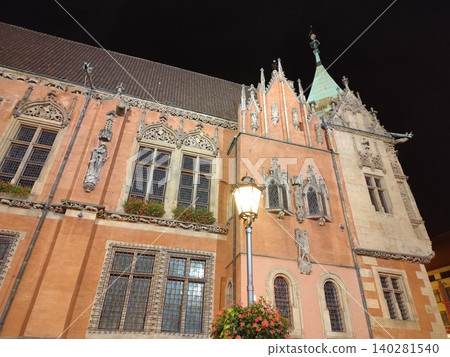 Old Town City Hall Building in Wroclaw Poland with Gothic Architecture Facade and Spires at Night. Street lamp light fixture Old Town City Hall Building in Wroclaw Poland with Gothic Architecture Facade and Spires at Night. Street lamp light fixture 140281540