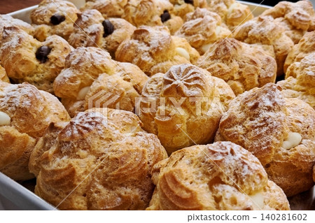 Light and airy choux pastry with a golden crust, filled with rich cream or custard. This elegant and versatile dessert offers a perfect balance of texture and sweetness. Light and airy choux pastry with a golden crust, filled with rich cream or custard. This elegant and versatile dessert offers a perfect balance of texture and sweetness. 140281602