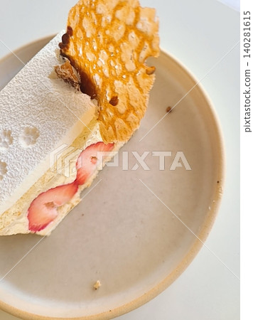 A delectable slice of cake with rich layers of cream and frosting, topped with fresh fruit or sprinkles. Perfect for dessert photography, showcasing indulgence and sweetness in food-related projects. 140281615