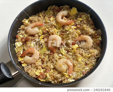 nasi goreng or fried rice traditional frying rice dish from indonesia made of Precooked rice fried in a small amount of oil, then spiced up with shallots, garlic, chili and sweet soy sauce. 140281640
