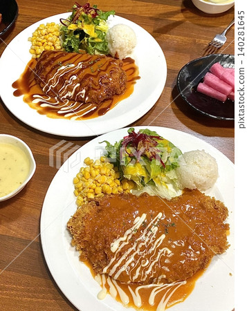 Crispy tonkatsu, a Japanese-style breaded and deep-fried pork cutlet, served with shredded cabbage and drizzled with savory sauce. A delightful balance of crunchy texture and juicy meat. Crispy tonkatsu, a Japanese-style breaded and deep-fried pork cutlet, served with shredded cabbage and drizzled with savory sauce. A delightful balance of crunchy texture and juicy meat. 140281645