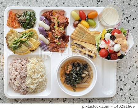 A vibrant spread of Korean food on the table, featuring various banchan (side dishes) like kimchi, pickled vegetables, and seasoned greens. Perfect for food photography, showcasing traditional Korean. 140281669