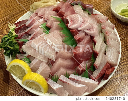 Fresh and delicate sashimi slices, beautifully presented with vibrant colors and perfect cuts. This traditional Japanese delicacy highlights the pure flavors of premium seafood. 140281740