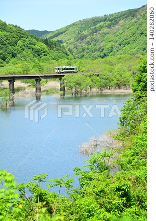 A diesel train crossing the full Kinshu Lake. A diesel train crossing the full Kinshu Lake. 140282060