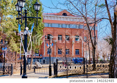 Historical brick building with wrought iron fence near Grodekov Museum in Khabarovsk Historical brick building with wrought iron fence near Grodekov Museum in Khabarovsk 140282485