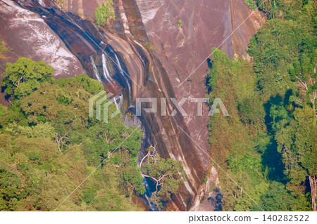 Rocky mountain waterfall surrounded by dense tropical rainforest near Langkawi Sky Bridge Malaysia Rocky mountain waterfall surrounded by dense tropical rainforest near Langkawi Sky Bridge Malaysia 140282522