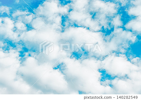 White, fluffy cumin clouds spread across the blue sky. White, fluffy cumin clouds spread across the blue sky. 140282549