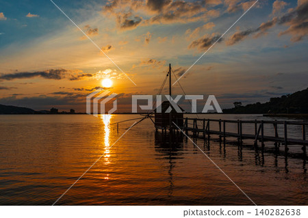 The sunset over Lake Togo, bathed in the colors of the setting sun. The sunset over Lake Togo, bathed in the colors of the setting sun. 140282638