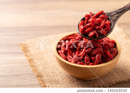 Organic dried goji berries in a wooden bowl with spoon. Healthy food Organic dried goji berries in a wooden bowl with spoon. Healthy food 140283039