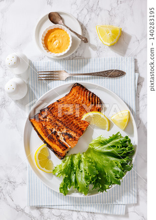 Grilled salmon steak on plate with fresh salad Grilled salmon steak on plate with fresh salad 140283195