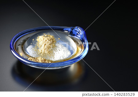 Mizuwara mochi served in a glass bowl, photographed against a black background. Mizuwara mochi served in a glass bowl, photographed against a black background. 140283529