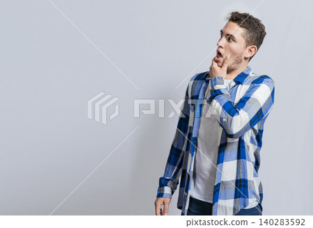 Bearded guy with surprised face with open mouth looking to the side. Man with wow face looking at a promotion to side Bearded guy with surprised face with open mouth looking to the side. Man with wow face looking at a promotion to side 140283592