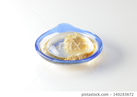 Mizuwara mochi served in a glass bowl, photographed against a white background. Mizuwara mochi served in a glass bowl, photographed against a white background. 140283672