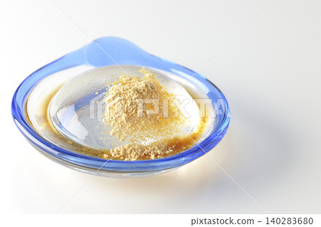 Mizuwara mochi served in a glass bowl, photographed against a white background. 140283680