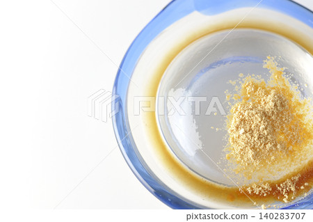 Mizuwara mochi served in a glass bowl, photographed against a white background. Mizuwara mochi served in a glass bowl, photographed against a white background. 140283707
