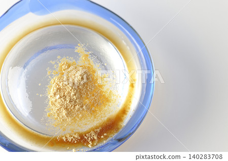 Mizuwara mochi served in a glass bowl, photographed against a white background. Mizuwara mochi served in a glass bowl, photographed against a white background. 140283708