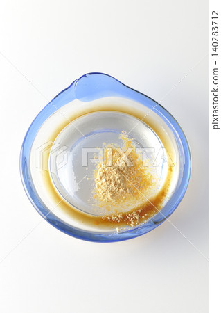 Mizuwara mochi served in a glass bowl, photographed against a white background. Mizuwara mochi served in a glass bowl, photographed against a white background. 140283712