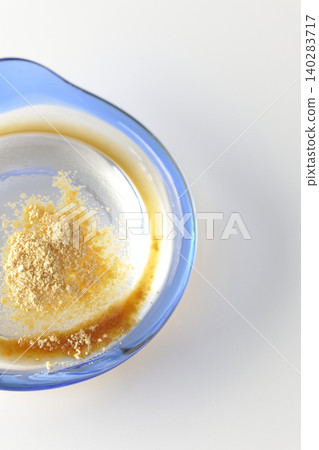 Mizuwara mochi served in a glass bowl, photographed against a white background. 140283717