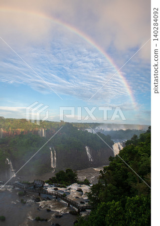 Breathtaking beautiful rainbow over majestic iguazu falls in lush green jungle Breathtaking beautiful rainbow over majestic iguazu falls in lush green jungle 140284092