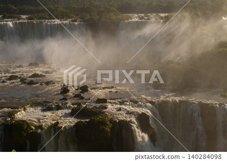 Massive iguazu falls cascade pouring powerful water mist creating awe 140284098