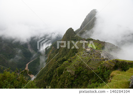 Mysterious thick fog surrounds ancient machu picchu mountain ruin creating awe 140284104