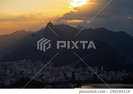 Beautiful sunset over mountain silhouette and cityscape of Rio de Janeiro Brazil truly serene and iconic view 140284114