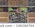 Insect house in summer garden. Bug hotel. Shelter for insect in outdoor. Insect ecosystem. 140284764