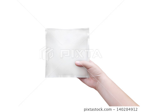An empty white foil bag in hand, against a white background. An empty white foil bag in hand, against a white background. 140284912