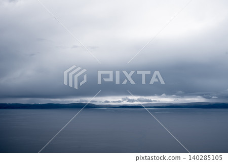 View of Lake Titicaca from Amantani Island under stormy clouds 140285105