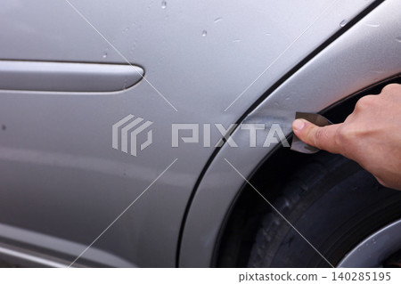 打磨汽車擋泥板上的刮痕的過程。 打磨汽車擋泥板上的刮痕的過程。 140285195