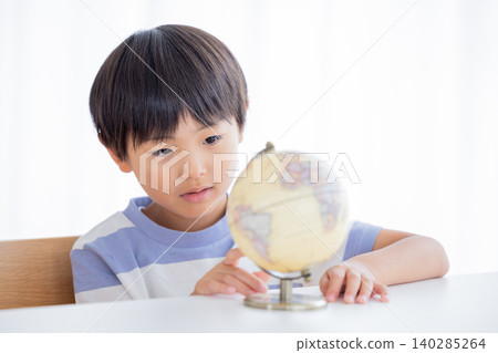 A boy looking at a globe A boy looking at a globe 140285264