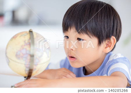 A boy looking at a globe A boy looking at a globe 140285266