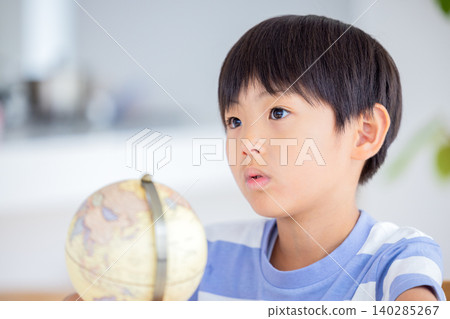 A boy looking at a globe 140285267