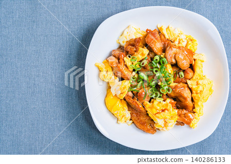 A photo of a Japanese-style dish of teriyaki chicken and egg stir-fried in a sweet and savory sauce. A photo of a Japanese-style dish of teriyaki chicken and egg stir-fried in a sweet and savory sauce. 140286133