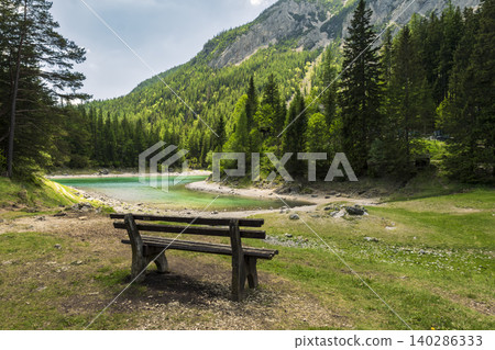 Wooden bench overlooking the Gruner See in Austria, surrounded by mountains, evoking mental restoration through nature retreats Wooden bench overlooking the Gruner See in Austria, surrounded by mountains, evoking mental restoration through nature retreats 140286333