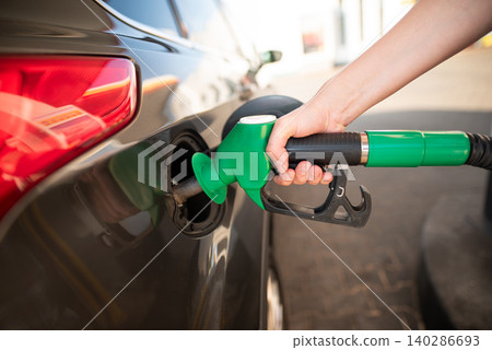 Refueling the vehicle at a gas station Refueling the vehicle at a gas station 140286693